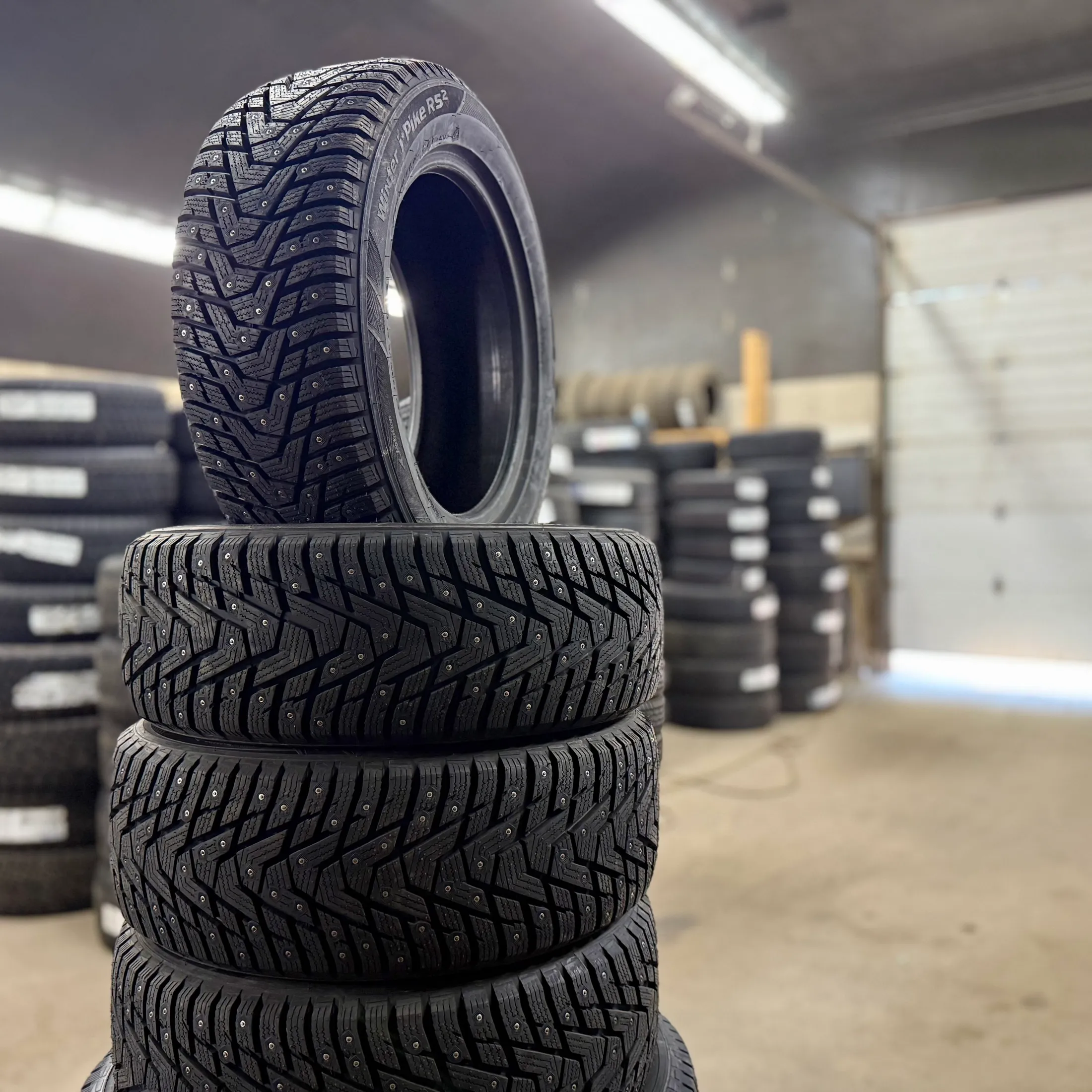 Studded winter tires stacked in the shop