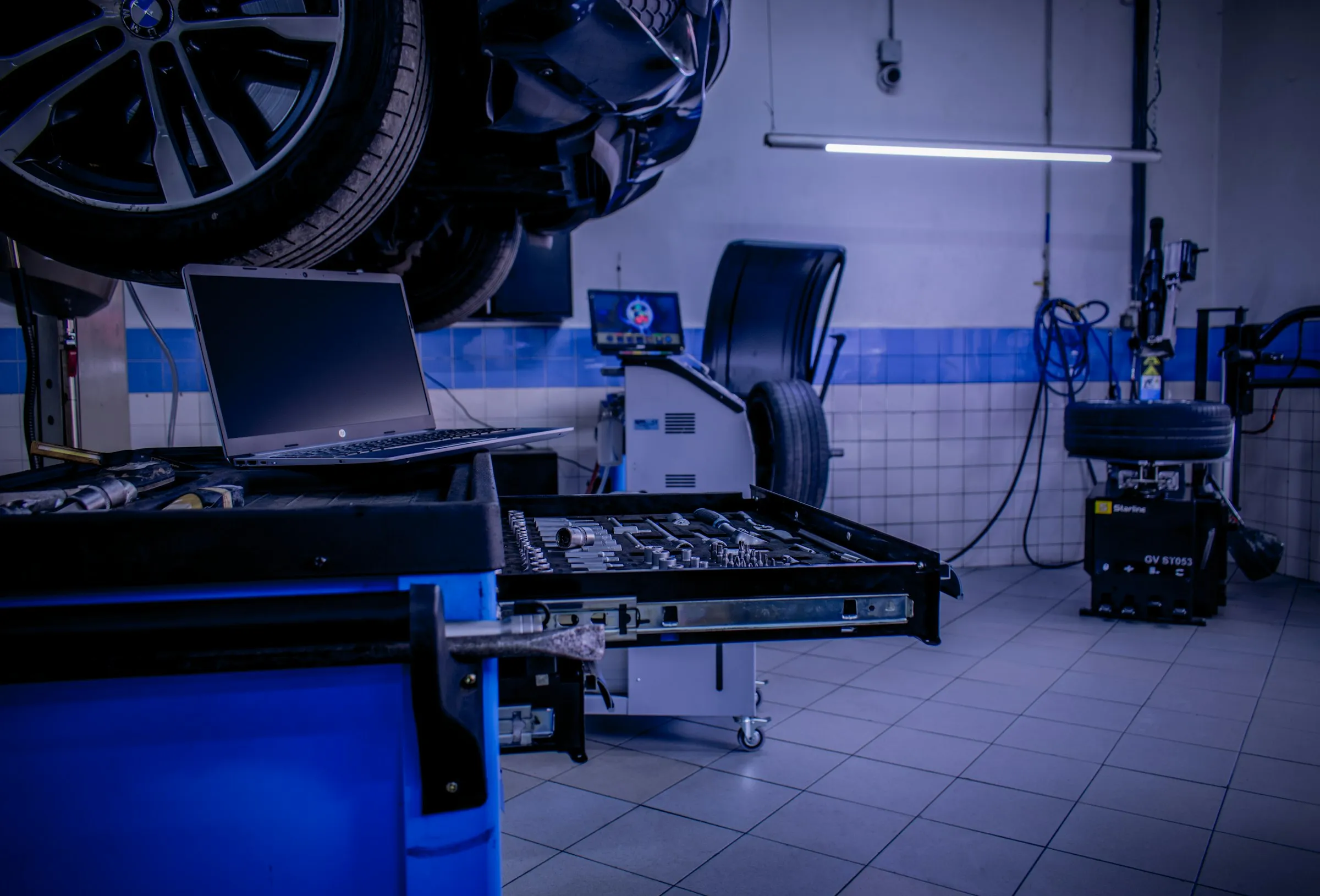 A vehicle on the alignment rack in the Rim2Rim shop