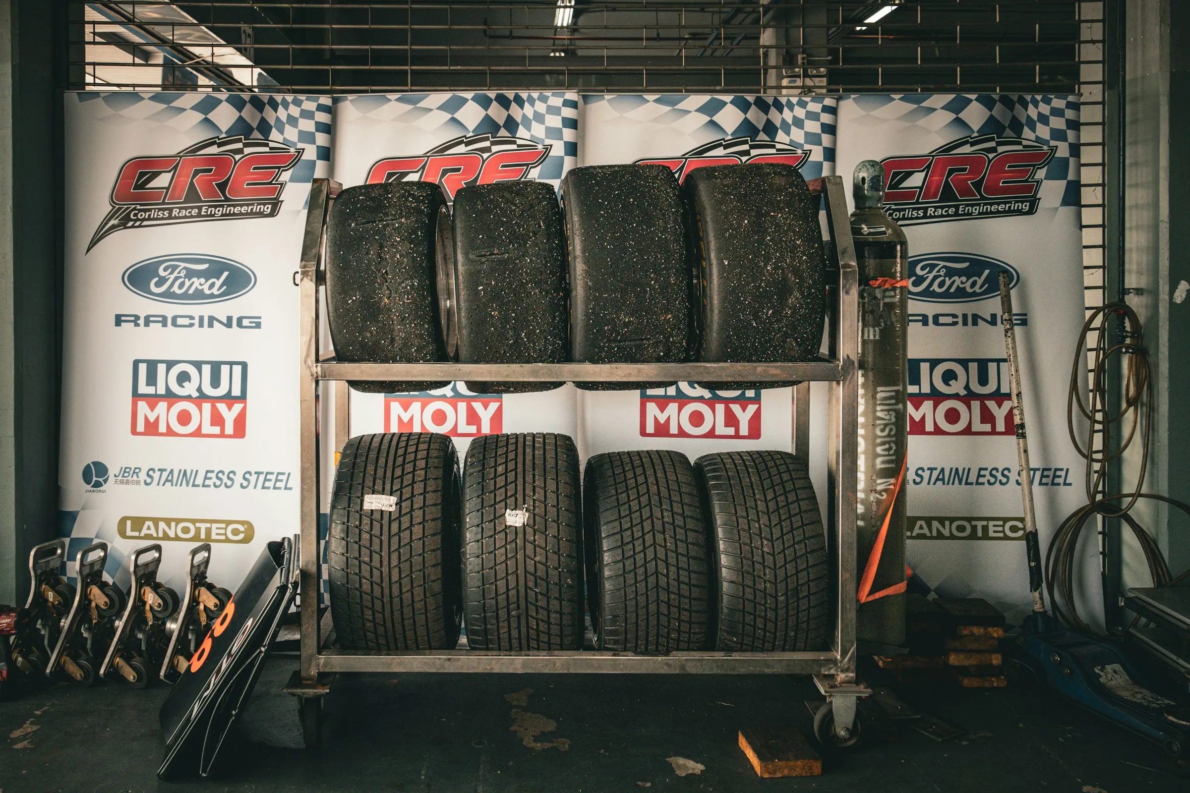 A set of winter tires on wheels stacked in the shop